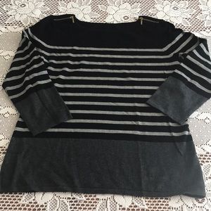 This sweater is gray and black, 3/4 length sleeves